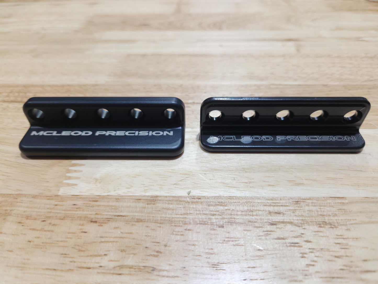 Picture of the V1 and V0 prototype minigrip side by side in black finish