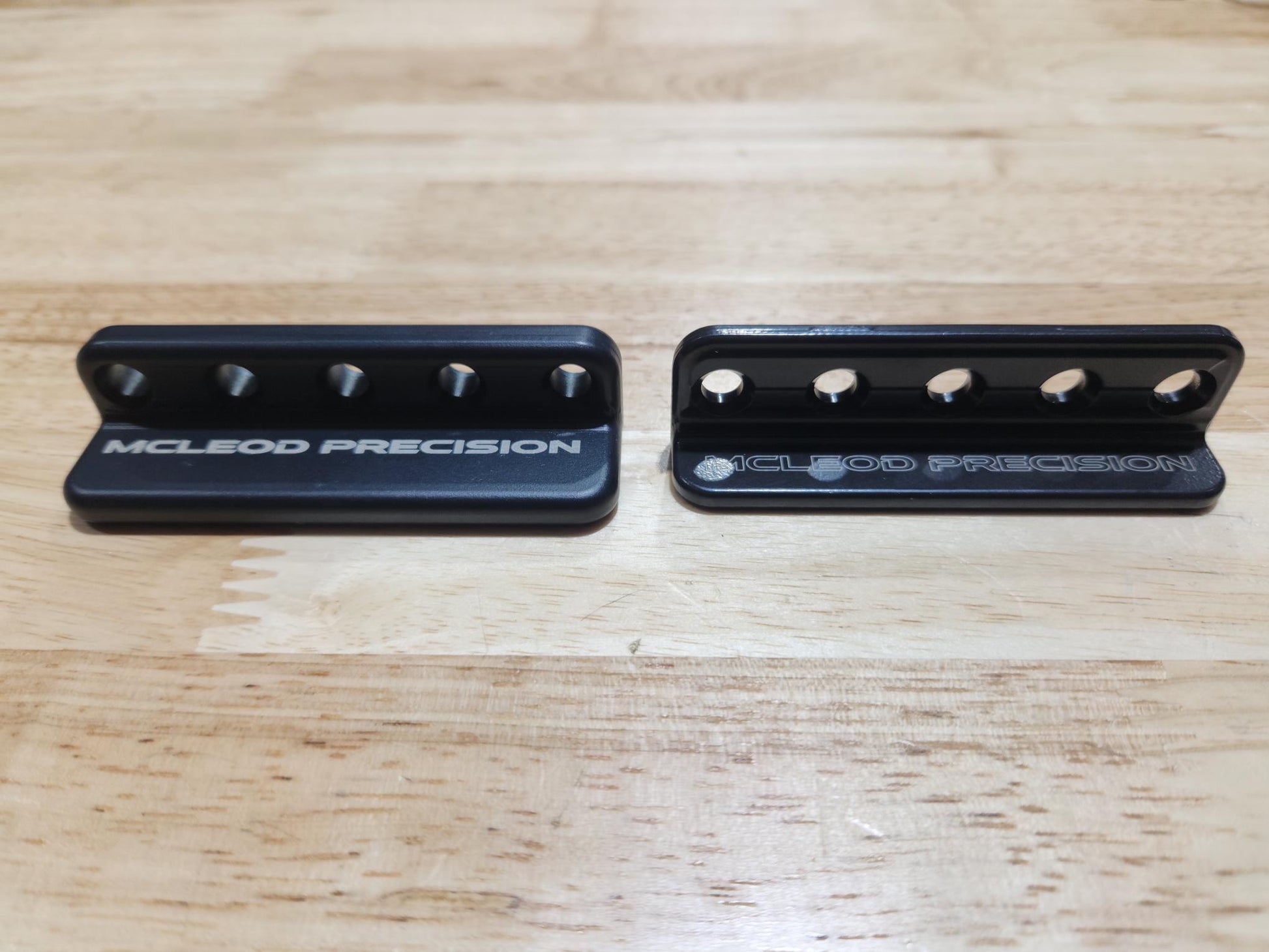 Picture of the V1 and V0 prototype minigrip side by side in black finish