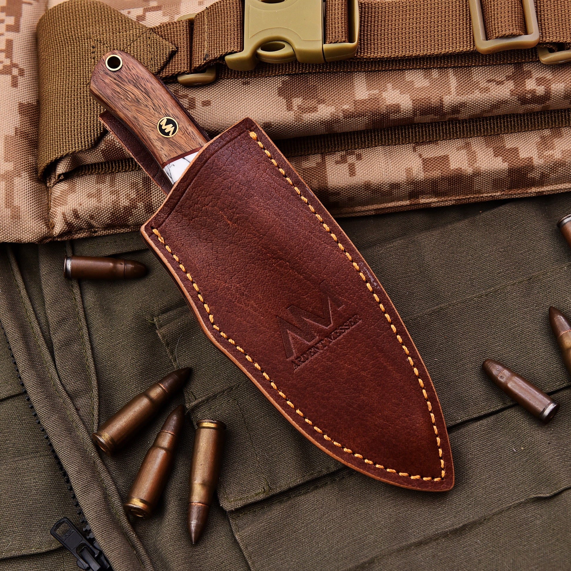 Brown leather knife sheath with visible branding on a camouflage background with bullets.