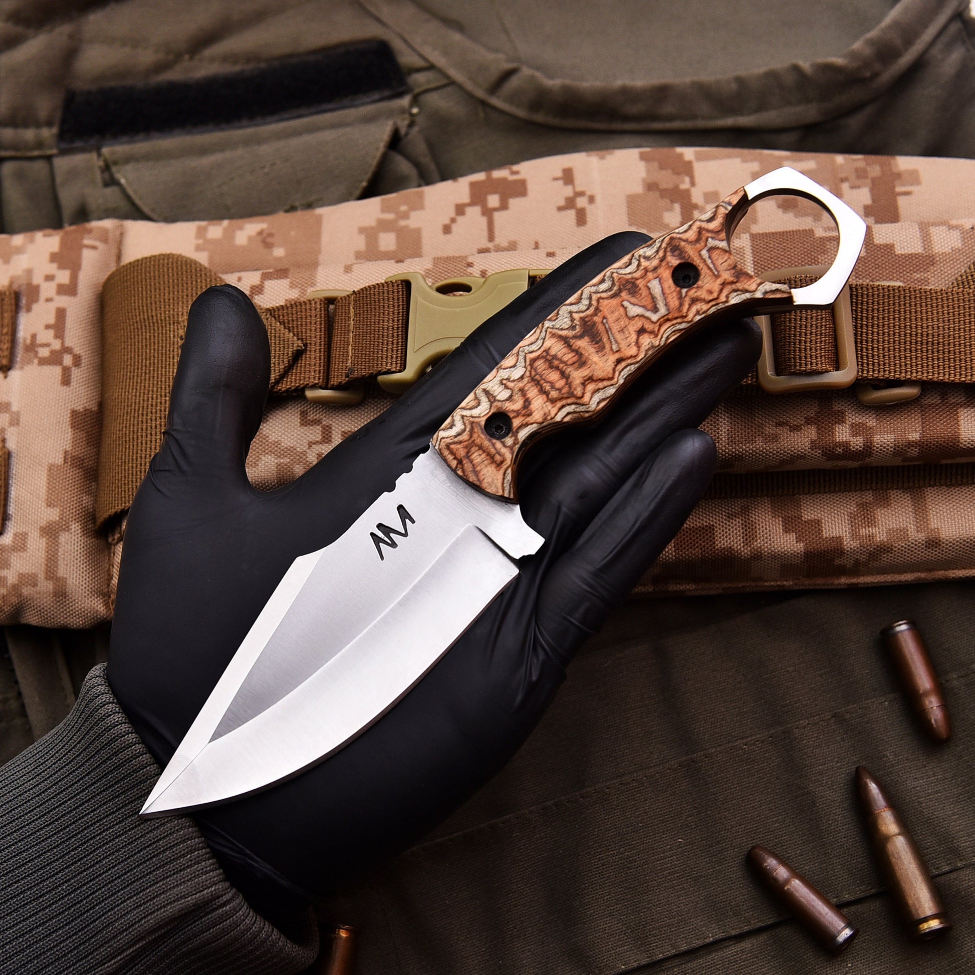Knife with a camouflage background and tactical gear