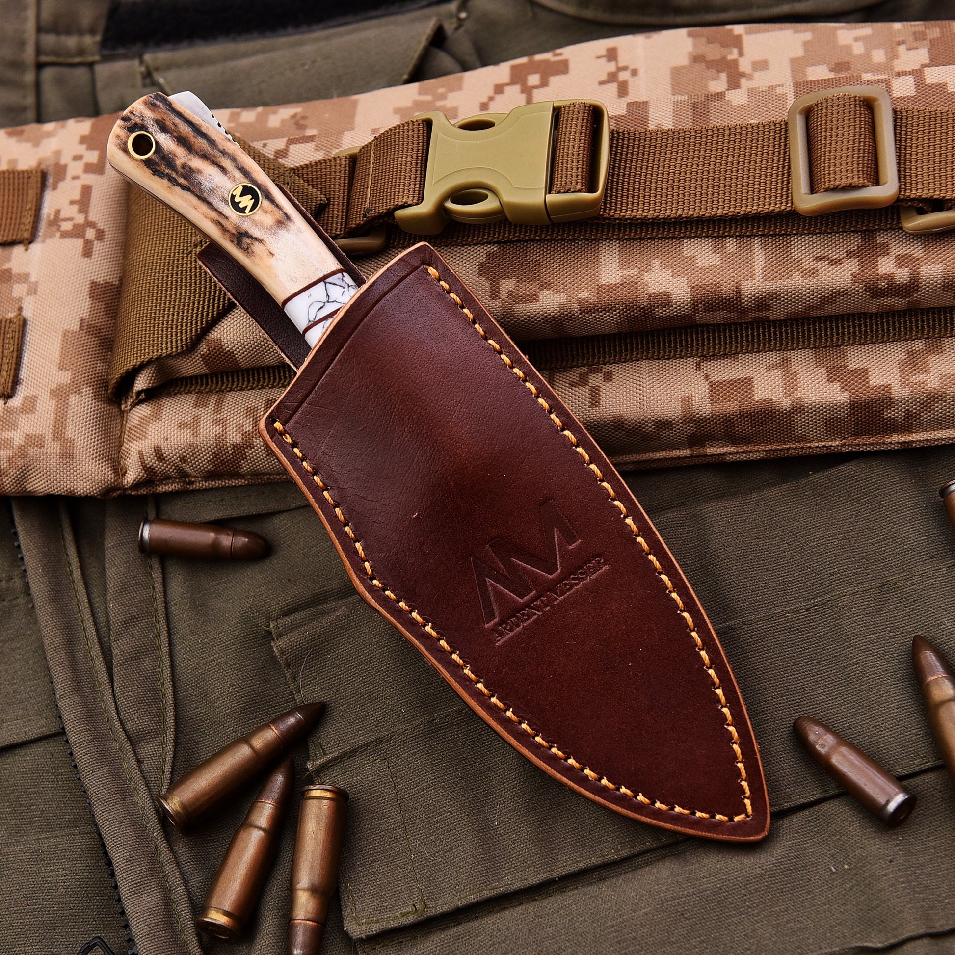 Knife with leather sheath on camouflage fabric with bullets