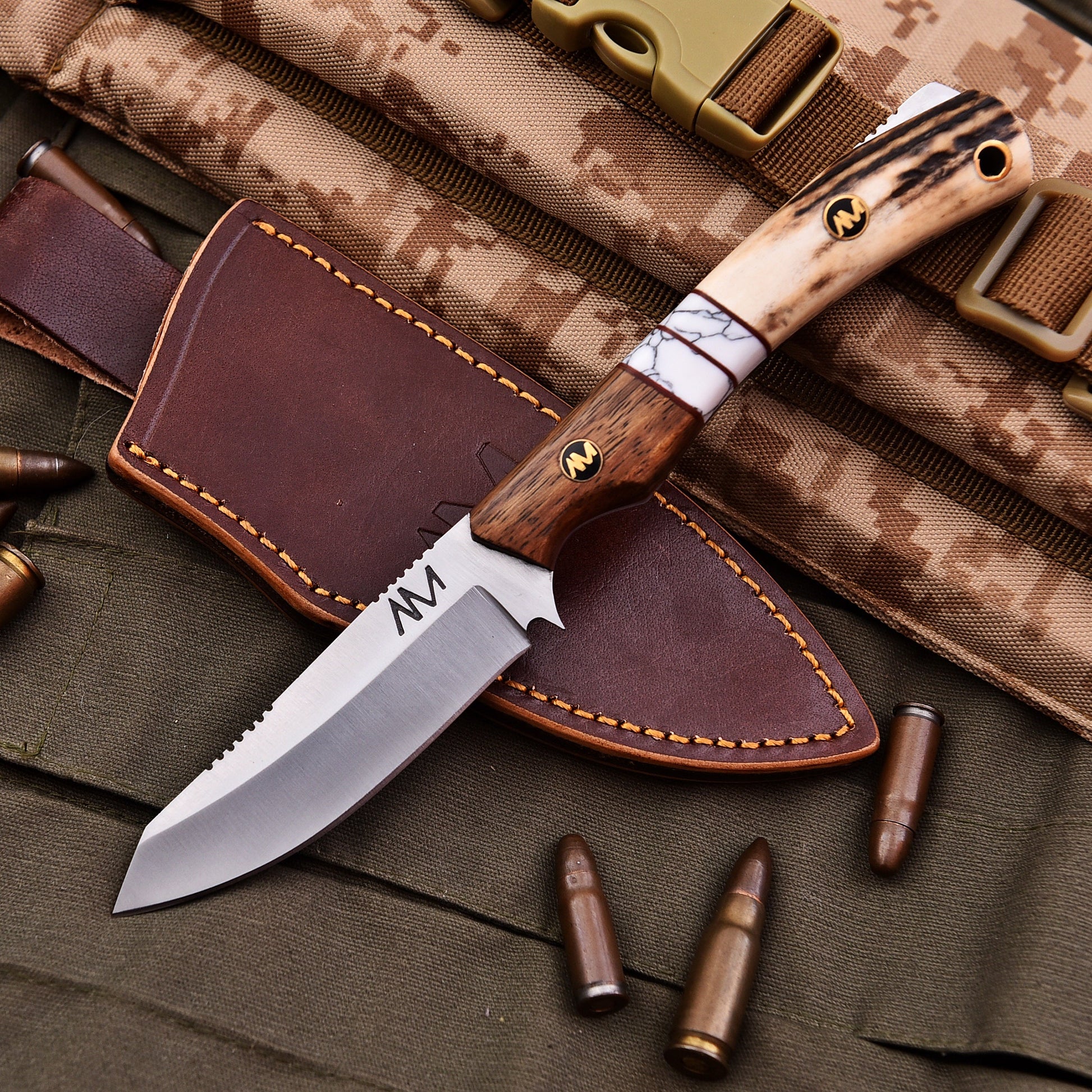 Knife with wooden handle and leather sheath on camouflage fabric background
