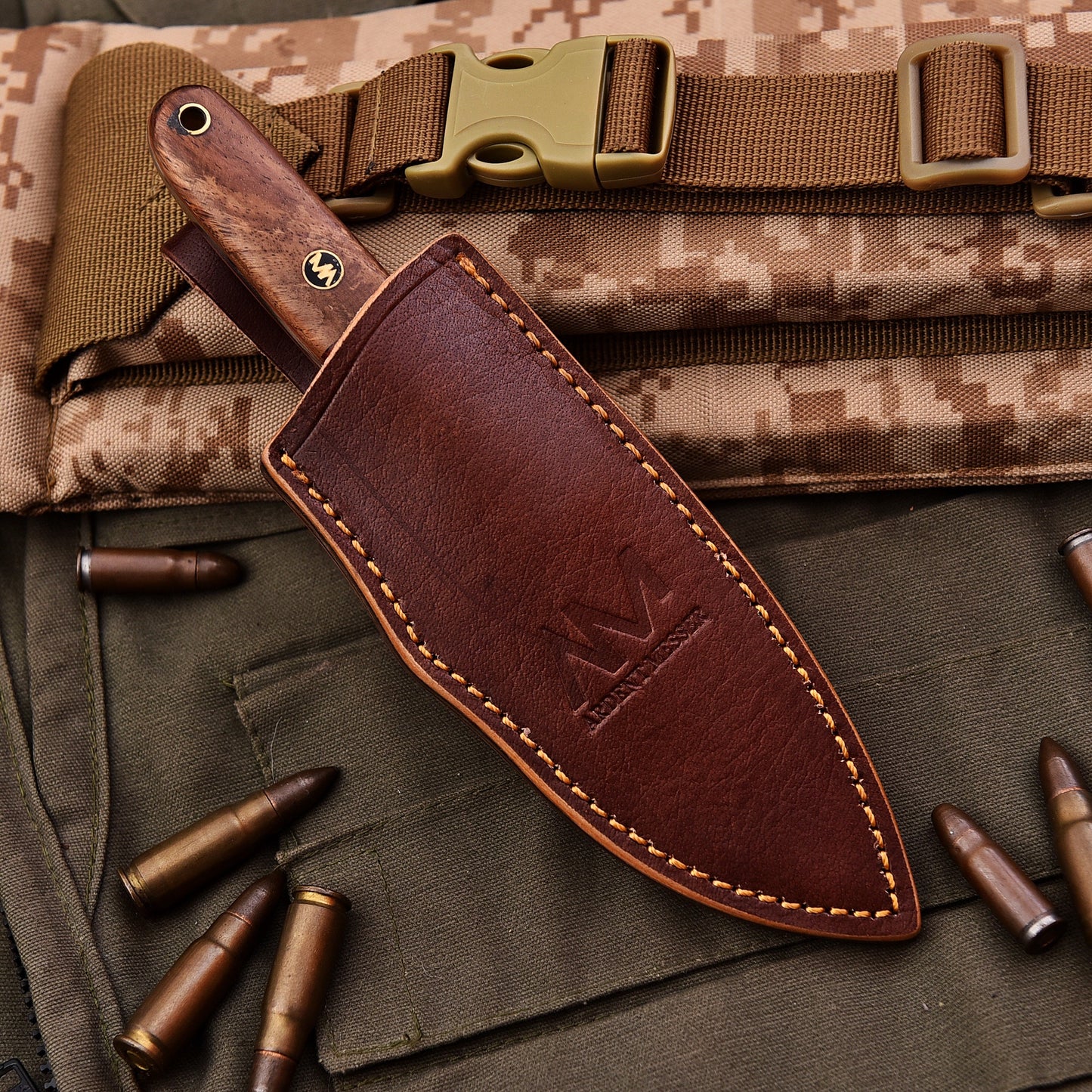 Brown leather knife sheath on a camouflage background with bullets