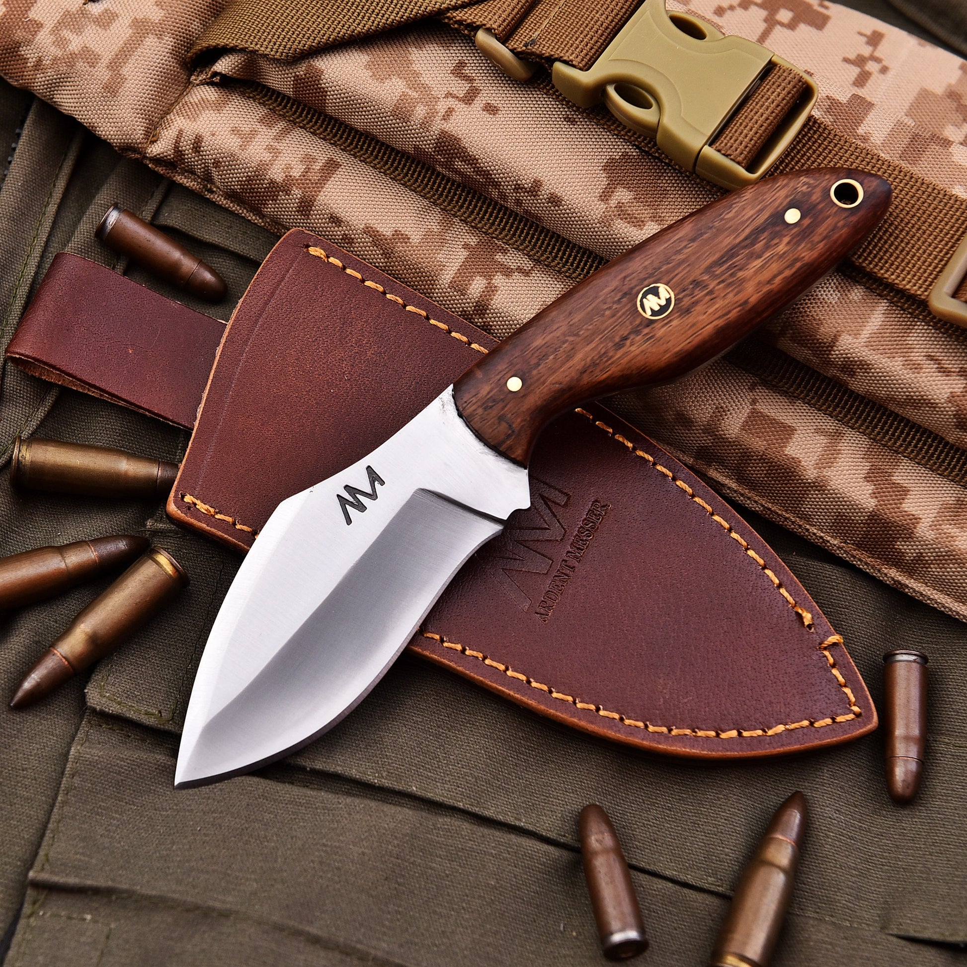 Knife with wooden handle and leather sheath on camouflage background