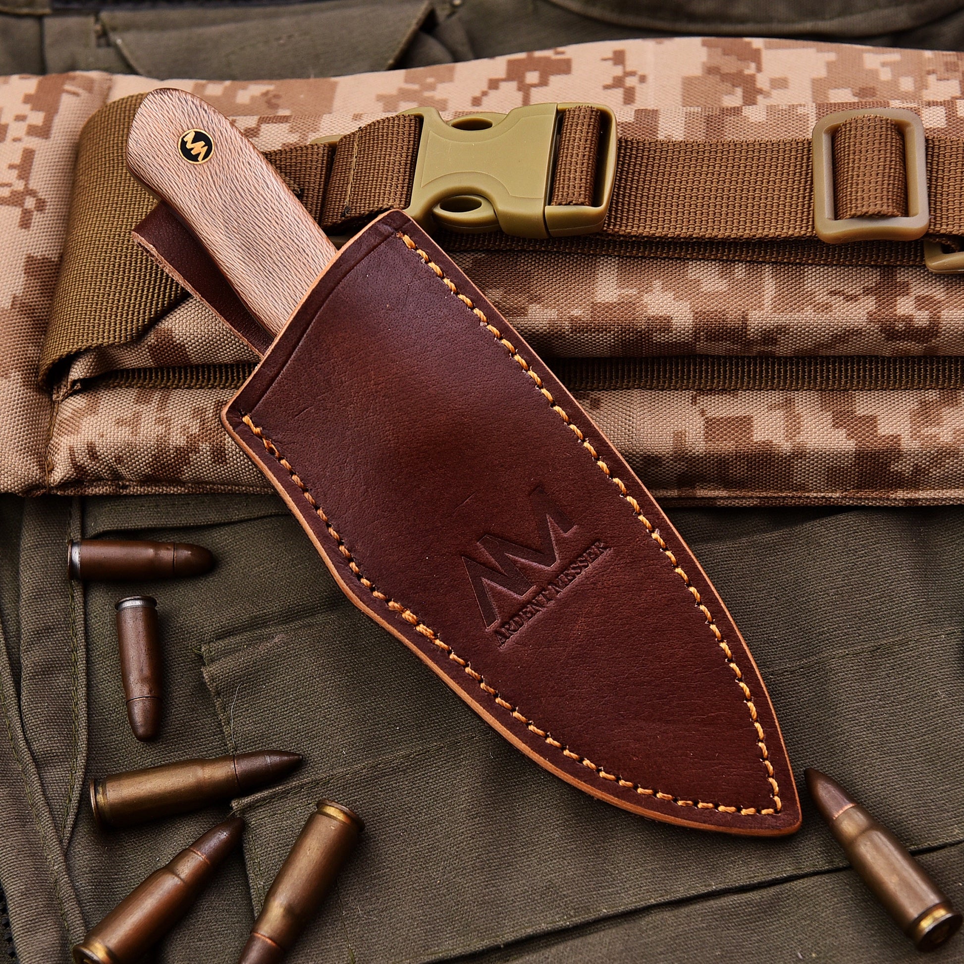 Brown leather knife sheath with a logo on a camouflage background with bullets