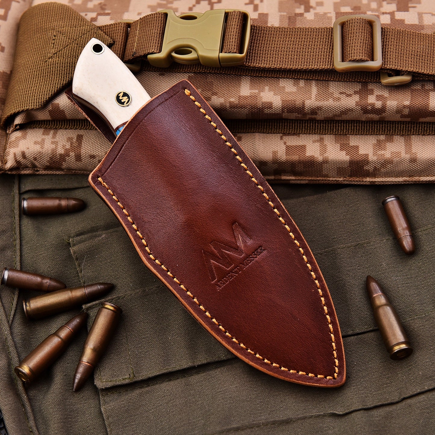 Brown leather knife sheath with visible branding on a camouflage background with bullets.
