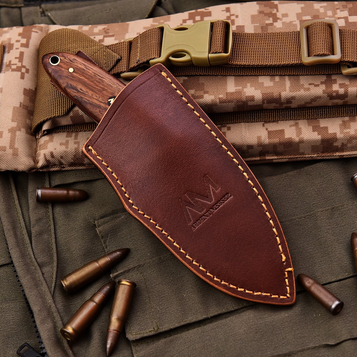 Brown leather knife sheath with stitching detail on a camouflage background