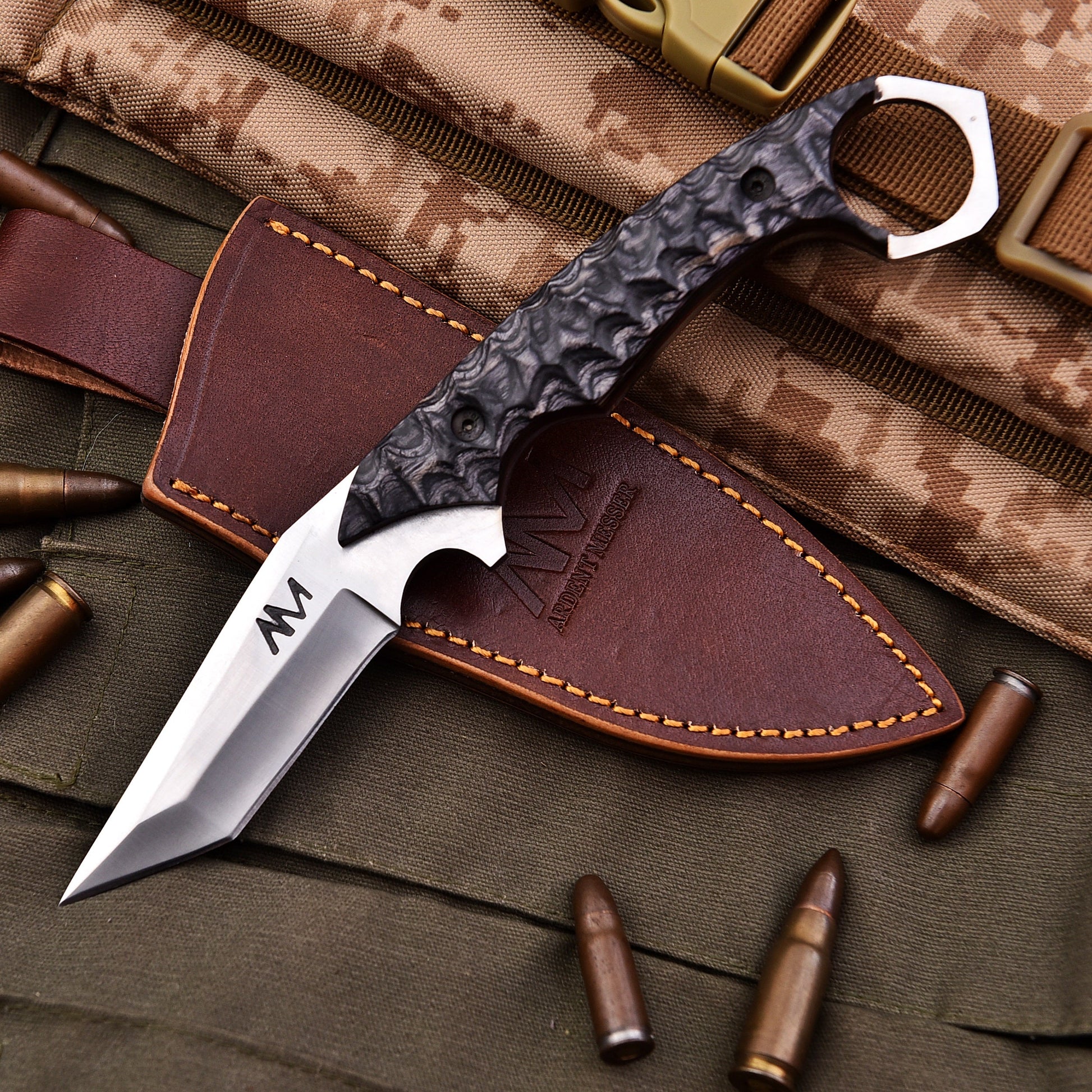 Knife with leather sheath on camouflage fabric with bullets